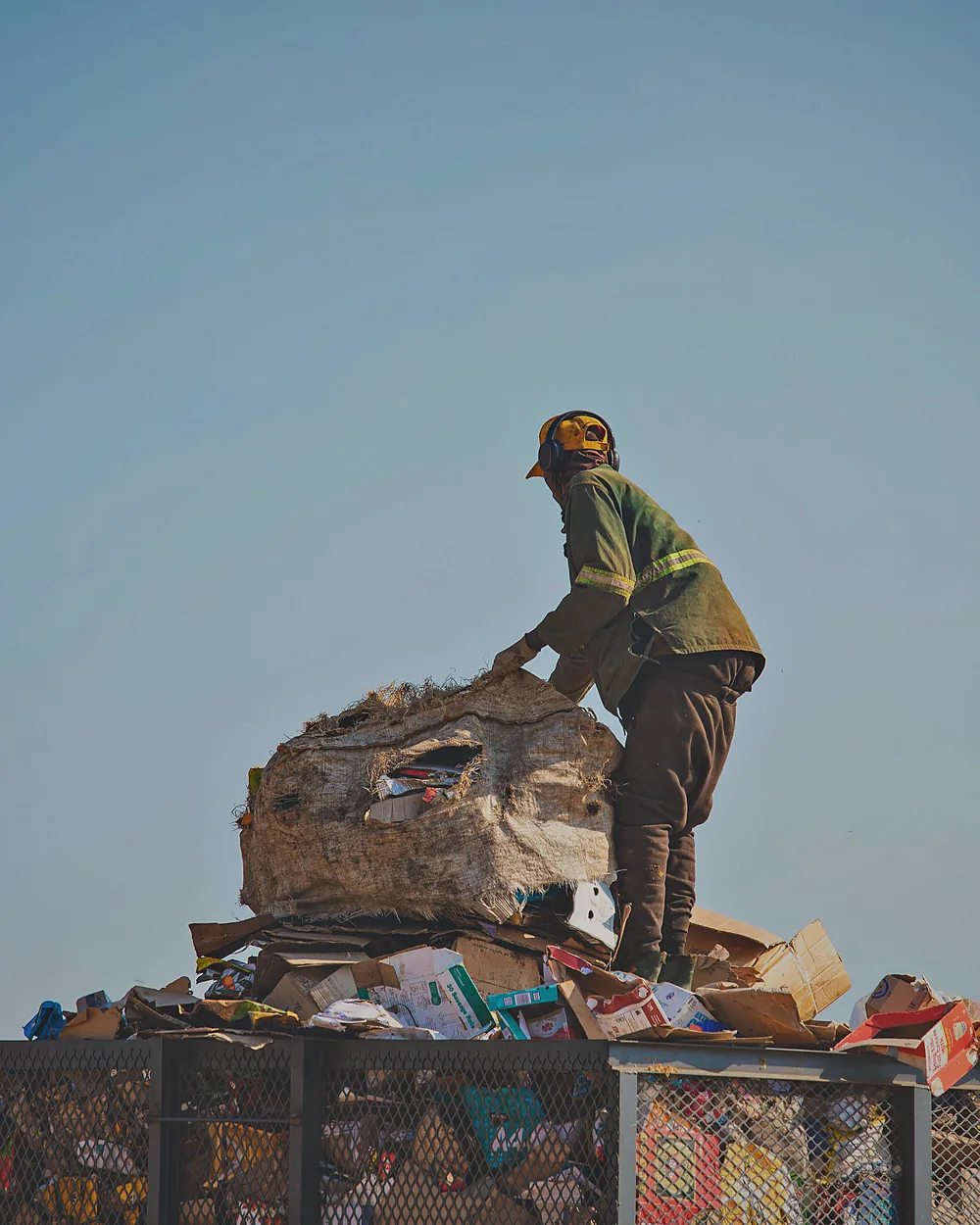 A Murero crew member working on top of a loaded cage at the sorting site.